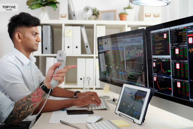 Traders analysing stock data on screens — investigating the question: are prop firms a scam?