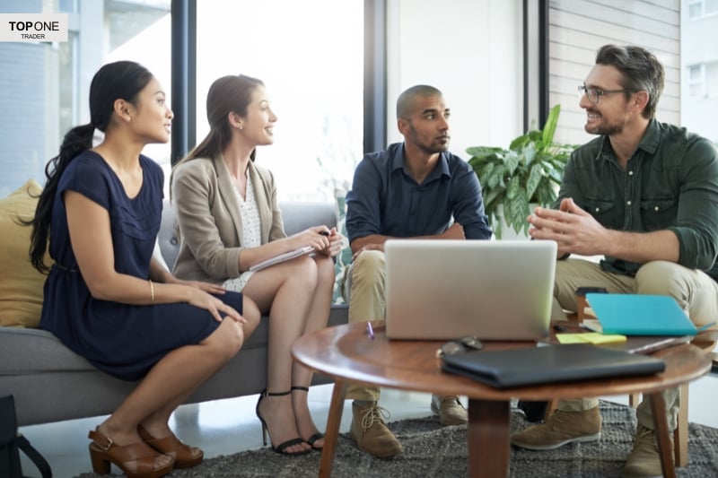 Team discussing profits, highlighting how much do prop firm traders make through collaboration.