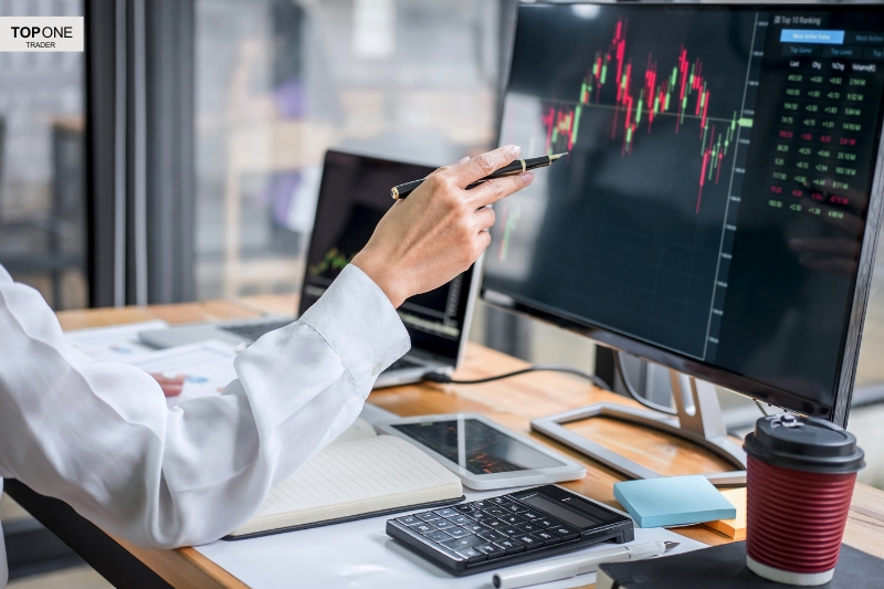 A trader analyses charts in a modern office—asking the key question: is prop trading worth it?